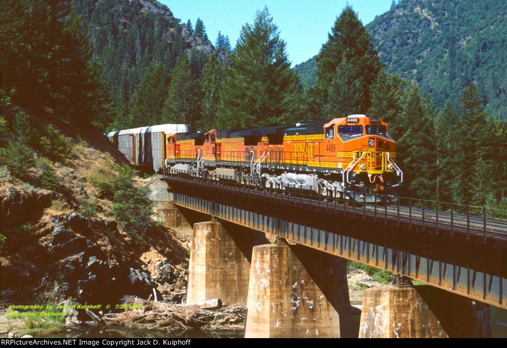 BNSF C44-9Ws 4469-4479-4447, leads a northbound autorack train over Indian Creek at Moccasin, California. July 28, 1999.